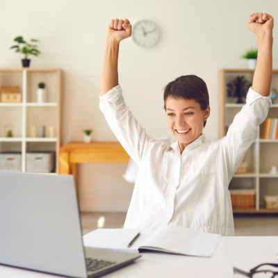 Person celebrating in a workspace.