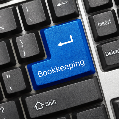 Computer keyboard with a large blue return key labelled 'Bookkeeping', symbolising digital or online bookkeeping services